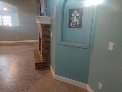 Corridor with ornamental molding, baseboards, and wood finished floors