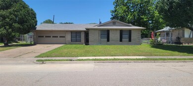 Ranch-style home featuring a front lawn and a gara