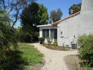 Side yard walkway leads to rear door of Garage and