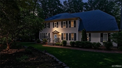 Colonial-style house with a front lawn