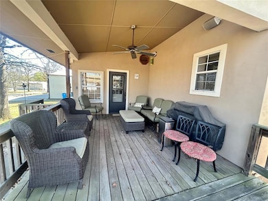Wooden deck featuring an outdoor living space and a ceiling fan