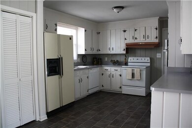 There are a TON of cabinets in this sunny kitchen and everything has been newly painted. There is also brand new flooring throughout the kitchen and dining room!
