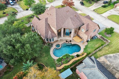 600 SF outdoor patio w/soaring 2-story ceiling overlooking pool, spa and manicured yard