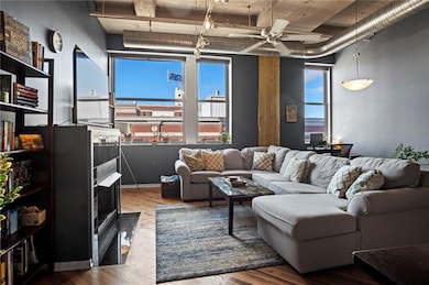 Living area featuring ceiling fan and wood finished floors