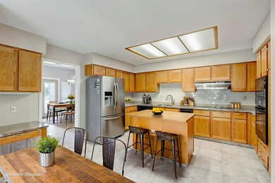 Large kitchen with island and desk has lots of storage!