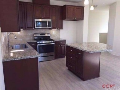 Kitchen with darker cabinets, stainless steel appl