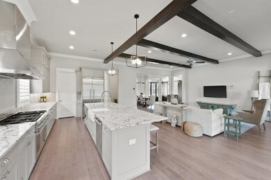 Inside you will love the open concept living area with custom beams, vaulted ceiling, and a kitchen that checks every box.