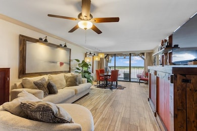 Living area with light wood-type flooring, a ceiling fan, and ornamental molding