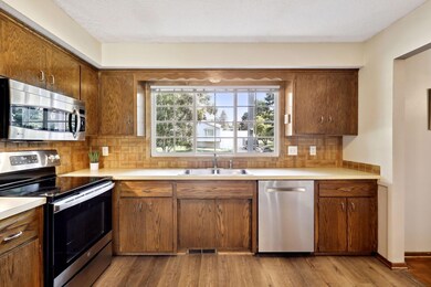 Kitchen overlooks front yard. New vinyl plank flooring in 2022.