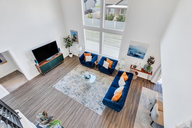 Living area featuring a towering ceiling and wood finished floors