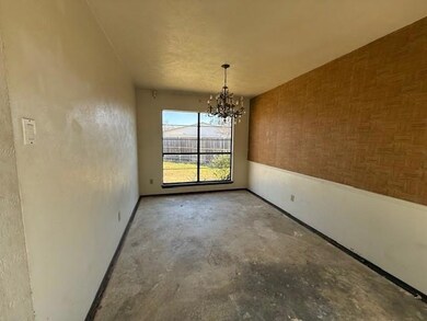 Unfurnished dining area with concrete floors and a