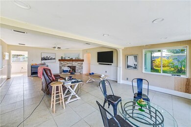 Tiled dining area featuring ceiling fan and a fire