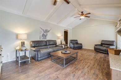 Living room featuring ceiling fan, dark hardwood /