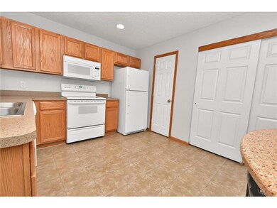 Half bath and access to the garage right off the k