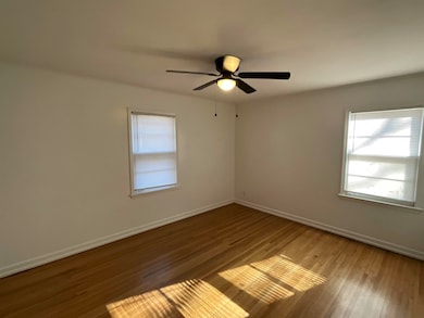 Empty room with ceiling fan and wood-type flooring
