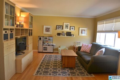 The living room is spacious with pretty hardwoods 