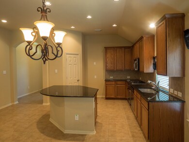 Let's get a closer look at the kitchen - granite countertops; an island with breakfast bar and storage; and lots of electrical outlets to plug in appliances or a laptop for recipes.  There's a lot of prep space here.  And, this kitchen is truly the hub of the home.