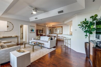 Living room featuring wood-type flooring, a raised