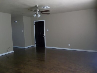 Spare room featuring ceiling fan and hardwood / wood-style floors