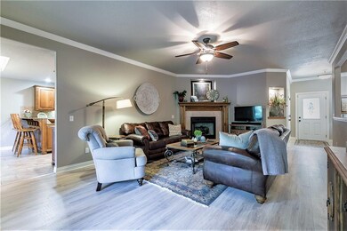 Crown molding and wonderful, durable wood laminate flooring in the very spacious 23 ft. living room