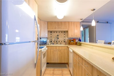 Kitchen featuring tasteful backsplash, light count