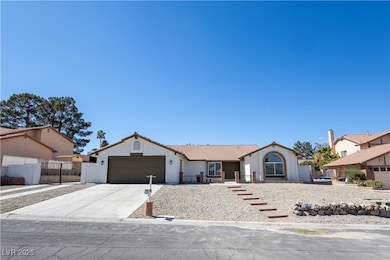 Ranch-style house with a tiled roof, an attached g