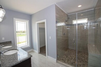 Beautifully tiled shower and walkin closet