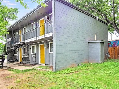 View of property exterior with fence, a lawn, a w