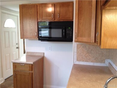 Kitchen. More kitchen detail, showing the side door entrance.  There is a coat closet across from this door.
