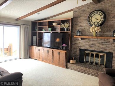 Living room with wood burning fireplace.