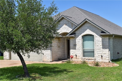 French country style house with stone siding, a sh
