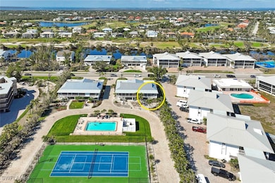 Birds eye view of property with a water view