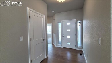 Inviting Entryway with coat closet and engineered wood flooring!
