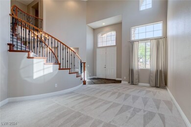 Foyer with high, vaulted ceilings and plentiful na