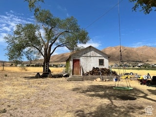 View of yard with a mountain view and an outdoor structure