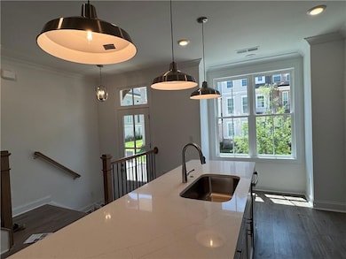Kitchen featuring a sink, baseboards, dark wood-st