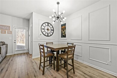 Dining room with light wood-style flooring, basebo