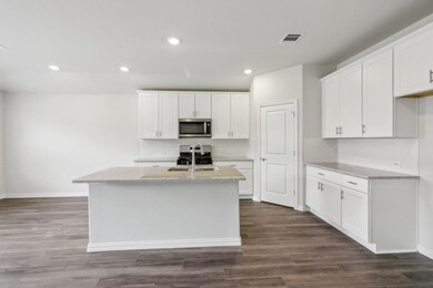 Kitchen with white cabinetry, Granite counters, st