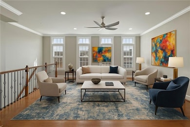 Living area with crown molding, a ceiling fan, and