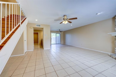 Unfurnished living room featuring a ceiling fan, 
