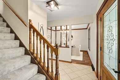 Staircase featuring tile patterned floors and baseboards