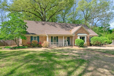 Ranch-style house with brick siding, a front yard,