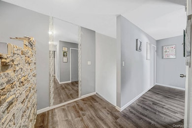 Hall featuring wood finished floors and baseboards