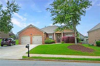 View of front facade with brick siding, a garage, and concrete driveway