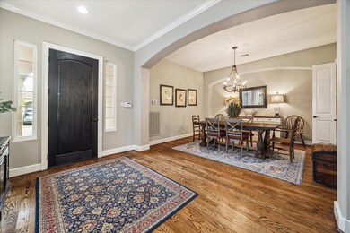 Formal dining room with wood flooring. Open to the