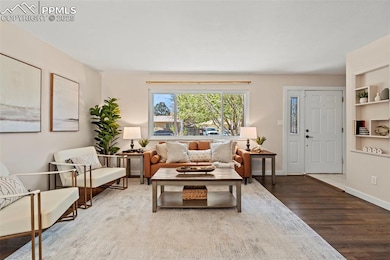 Living area with wood finished floors and built in features