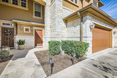 Entrance to property with a garage, stone siding,
