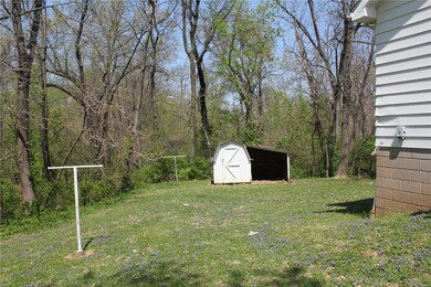 Side yard looking to backyard.  One acre of woods behind the house