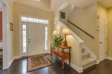 Bright 2 story foyer with dark wood floors