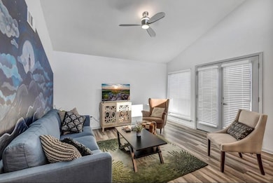 Living area with vaulted ceiling, visible vents, 